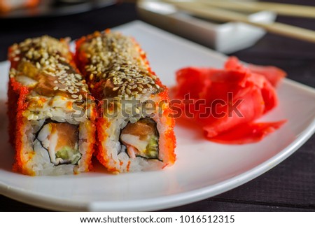 sushi rolls with eel in flying fish roe