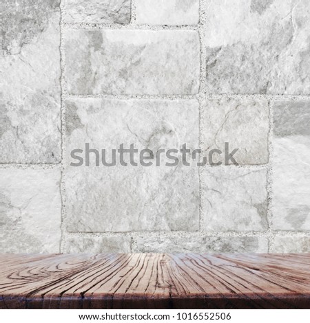 Wood table top with blurred  white and gray color marbles stone tile design background - can be used for display or montage your products.