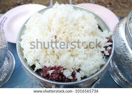 Jasmine rice in white jar on wooden floor