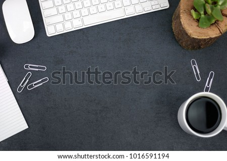 Office Desk with Keyboard, Succulent Plant, Paper, Coffee and Computer Mouse Over Black Background