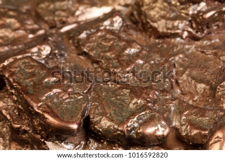 Nugget in bronze. A small lump of bronze in abstract forms, modeled and painted for a decorative object. Macro. Amazing pattern for conceptual design projects. Extreme close up. Conceptual picture. 