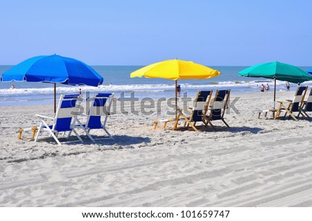 Row of beach chairs waiting for sun bathers
