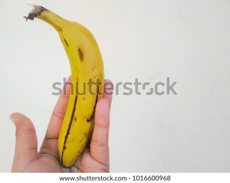 Holding fresh organic banana on hand