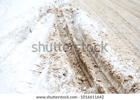 Trail from the truck in the snowdrift