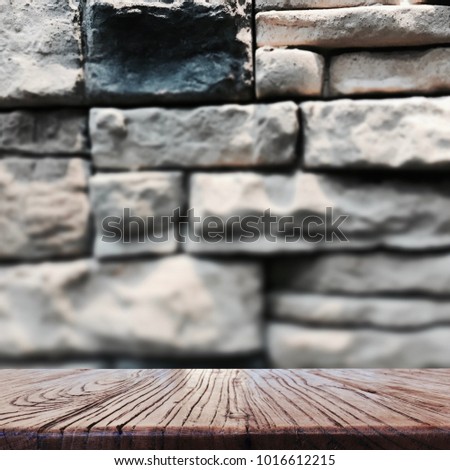 Wood table top with blurred brown brick tile design for background - can be used for display or montage your products.