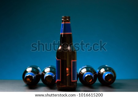 Empty bottle in standing position with other bottles lying down. Glass bottles positioned on fancy background. Social media concept for posters and banners and other design projects. Network concept.
