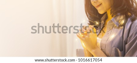 Portrait of teenager woman hand praying. Asian woman praying on the bed in the morning. Hands folded in prayer on the bed in the morning concept for faith, spirituality and religion banner
