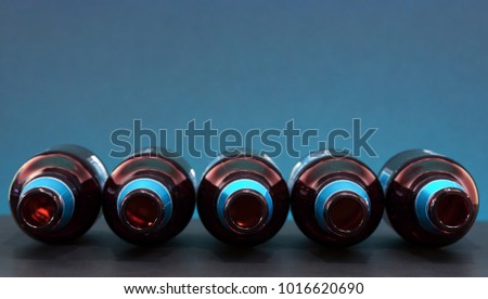 Empty bottles positioned horizontally with top view. Glass bottles picture on fancy background. Social media concept for banners and other design projects. Media network conceptual picture. 