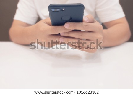 Close-up Man's hands use pointing finger Mobile smart Phone on Food table, technology and home concept soft focut blur