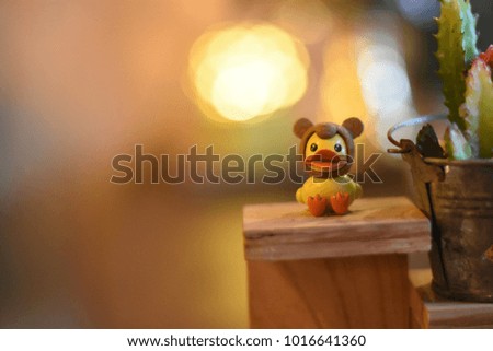 Ducky doll on a table and blur background. 