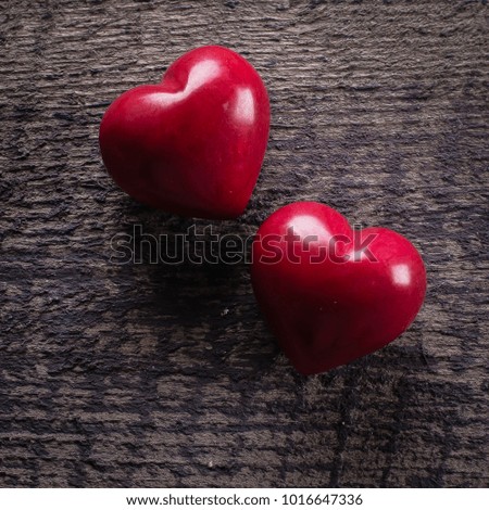 Red Ceramics Hearts on wooden table. Valentine background