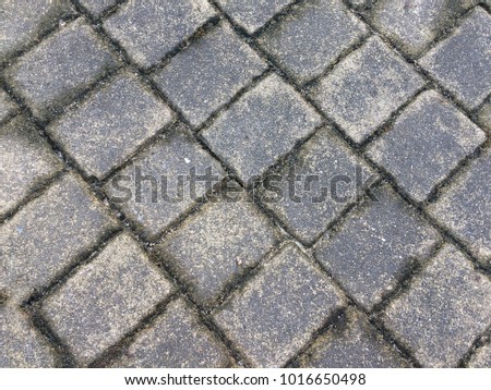 Old dirty concrete square block floor pattern dark texture for background.