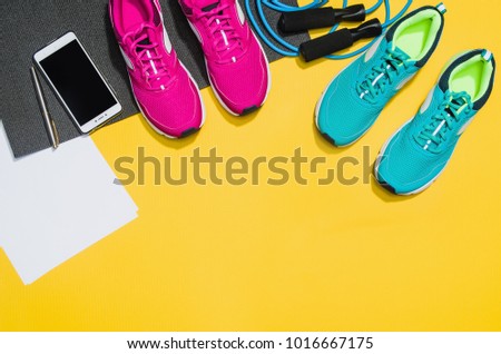 Fitness accessories, healthy and active lifestyles concept background with copy space for text. Products with vibrant, punchy pastel colours and frame composition. Image taken from above, top view.