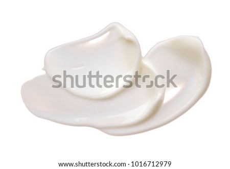 White smear of cosmetic cream isolated on white background. Creamy foundation texture isolated. Smear of face cream isolated. Texture of cream on white background