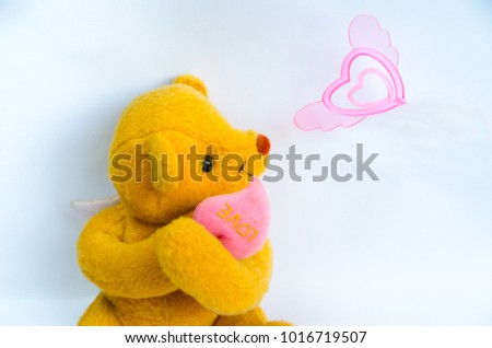 Cute teddy bears fall in love.He see flying heart with isolated on white background.Concept picture for valentine lover day