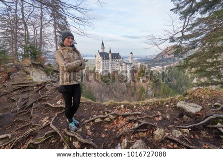 Woman traveler and the Neuschwanstein castle, Bavaria, Germany.        