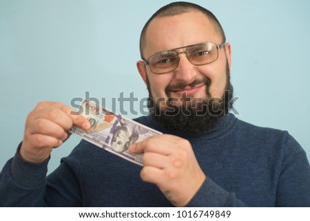 bearded man holding money