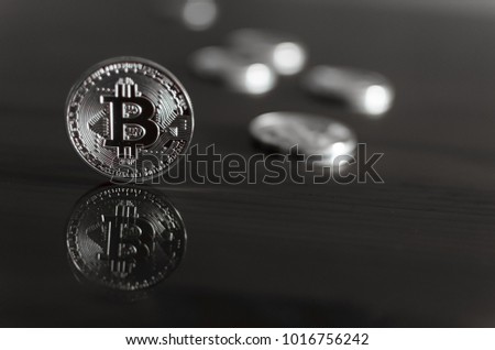 Bitcoin with reflection in the mirror,lots silver coins