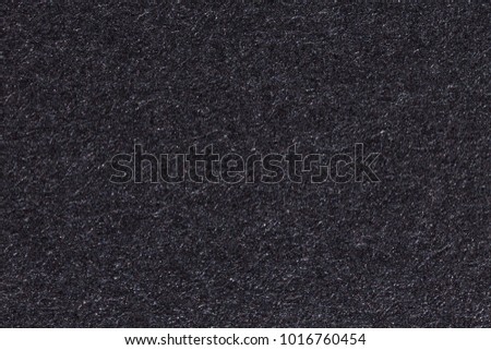 Black paper texture or background. High resolution photo.