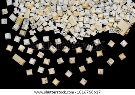 Stack of  white computer keyboard keys on isolated black background