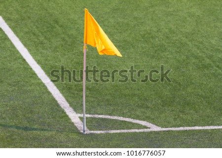 yellow flag blow on the pole at corner of football field