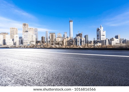 empty road with modern building and panoramic cityscape