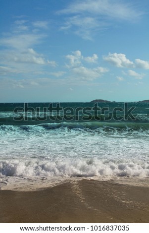 Azur sea water with blue waves, wind and  white foam on the waves Sea coast Picolo Pevero, Sardinia, Italy