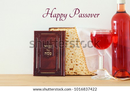 Pesah celebration concept (jewish Passover holiday). Traditional book with text in hebrew: Passover Haggadah (Passover Tale) Royalty-Free Stock Photo #1016837422
