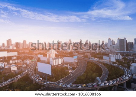 Traffic Jam over highway intersection with city business downtown skyline, cityscape background