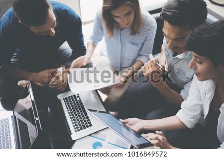 Business meeting concept.Coworkers team working new startup project at office.Analyze business documents, laptop on table.Blurred background.Horizontal. Royalty-Free Stock Photo #1016849572