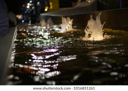 a colorful fountain with night light blurred background.