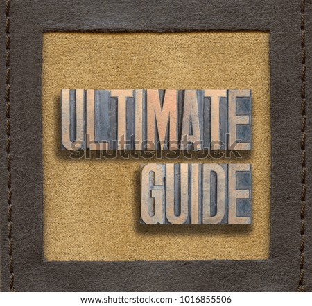 ultimate guide phrase assembled from vintage wooden letterpress inside stitched leather frame
