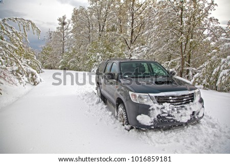 4x4 off-road vehicle or SUV on a snowy forest road in April 2017, Borzsony Mts - Hungary