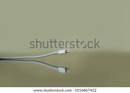 USB cable Lightning lying on the reflective surface