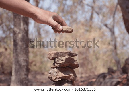 Human hands stacked stones.
