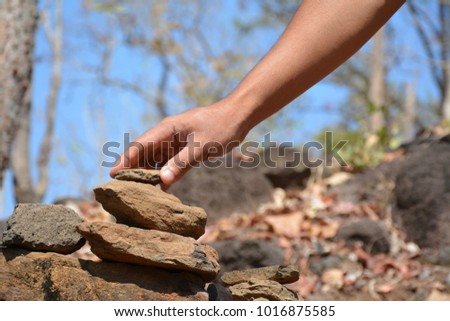 Human hands stacked stones.
