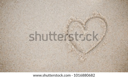 heart on a sand of beach on background