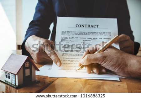 Agent give pen and documents insurance house with customer to sign contract. Agreement concept.