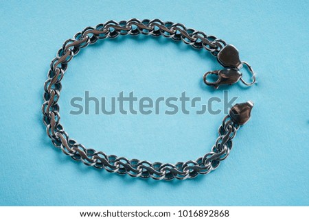 Silver bracelet on a blue background