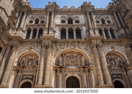 Baroque design of the main doors to the Malaga Cathedral in Malaga, Andalusia, Spain, Europe on a bright summer day