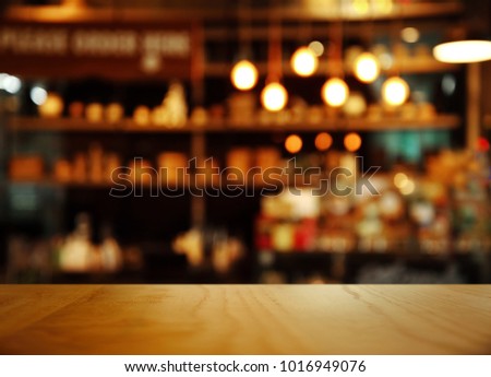 top of nature wood with blur lamp light bar or club cafe background Royalty-Free Stock Photo #1016949076