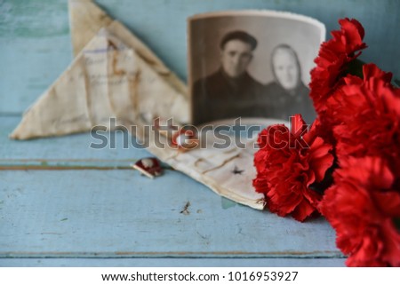 background for postcards by may 9, victory day: cap, letters, carnations and St. George ribbon Soviet icons and old photos