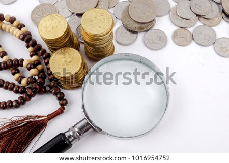 Rosary and coins. Islamic Banking/Finance concept.