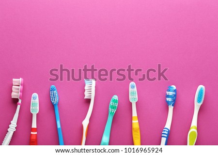Toothbrushes on pink background Royalty-Free Stock Photo #1016965924