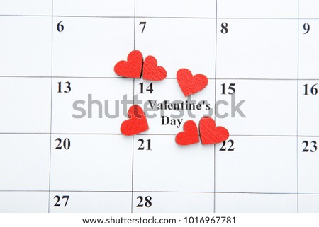 Red hearts on white february calendar
