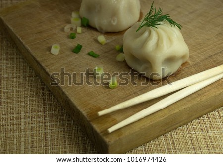 dumplings on a board with chopsticks