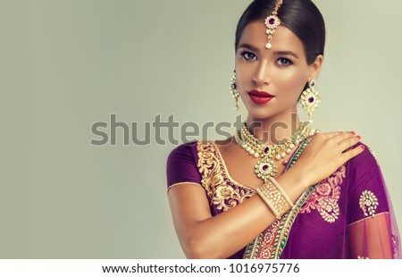 Portrait of beautiful indian girl. Young hindu woman model. Traditional India costume lehenga choli or sari Royalty-Free Stock Photo #1016975776