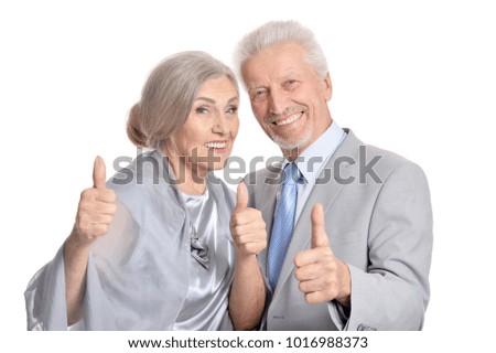 senior couple showing thumbs up