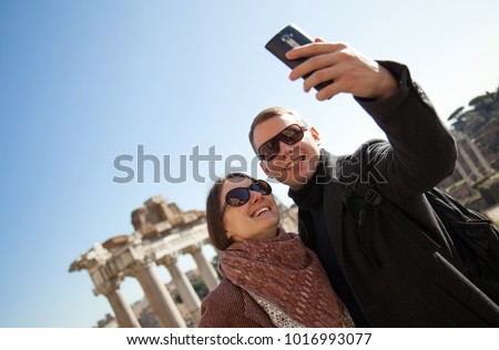 Happy young couple making selfie in Roman Forum at sunny day