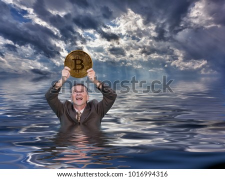 Senior man angry and holding bitcoin as he sinks into water after investing in the cybercurrency